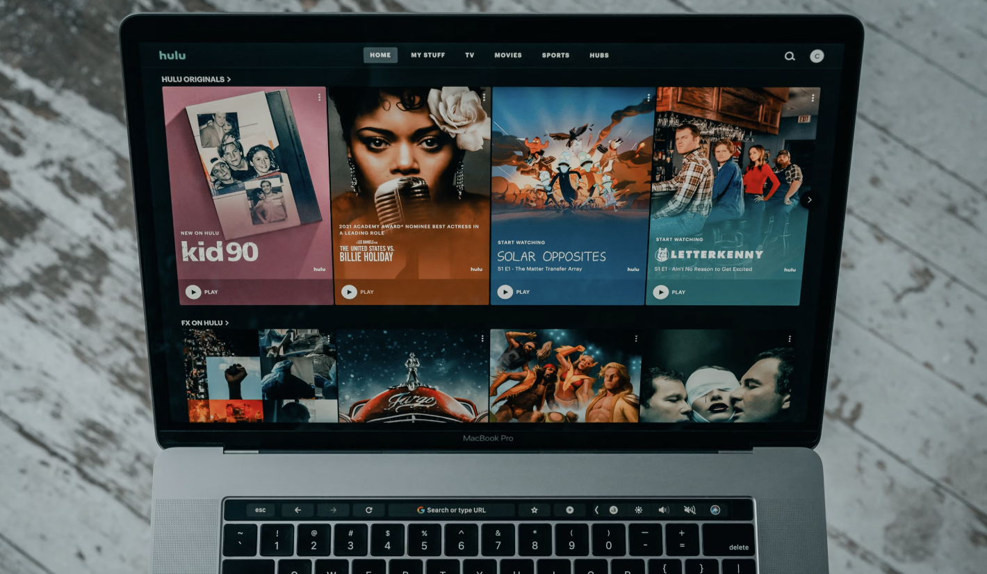 A person enjoying music on a smart device with the Amazon Music interface visible, displaying album covers and promotional banners for extended trials.